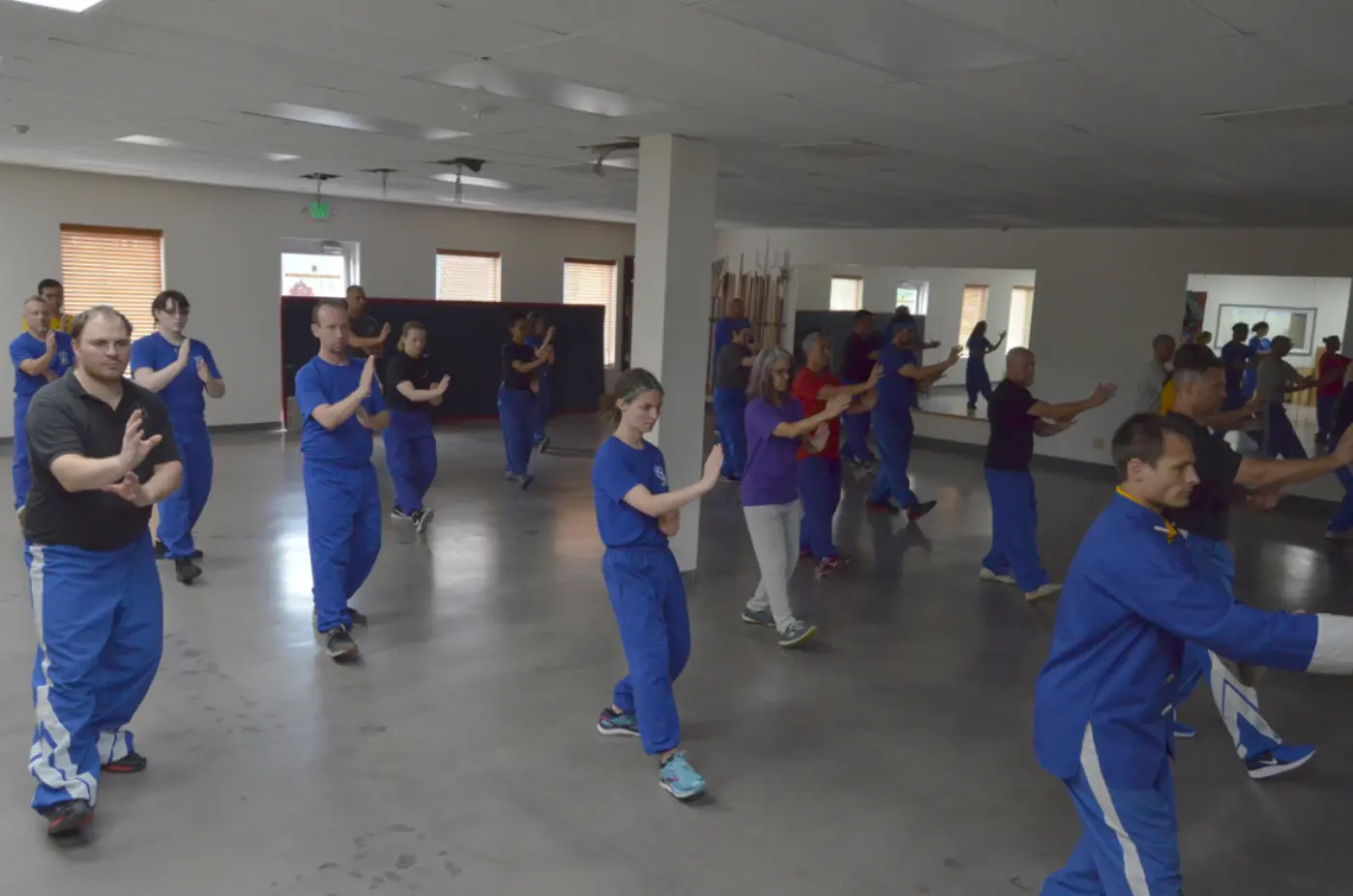A classroom of students doing Tai Chi