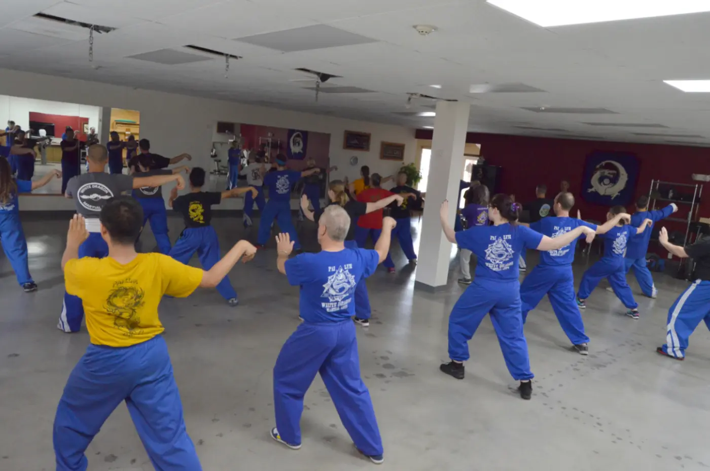 A classroom of students performing Tai Chi