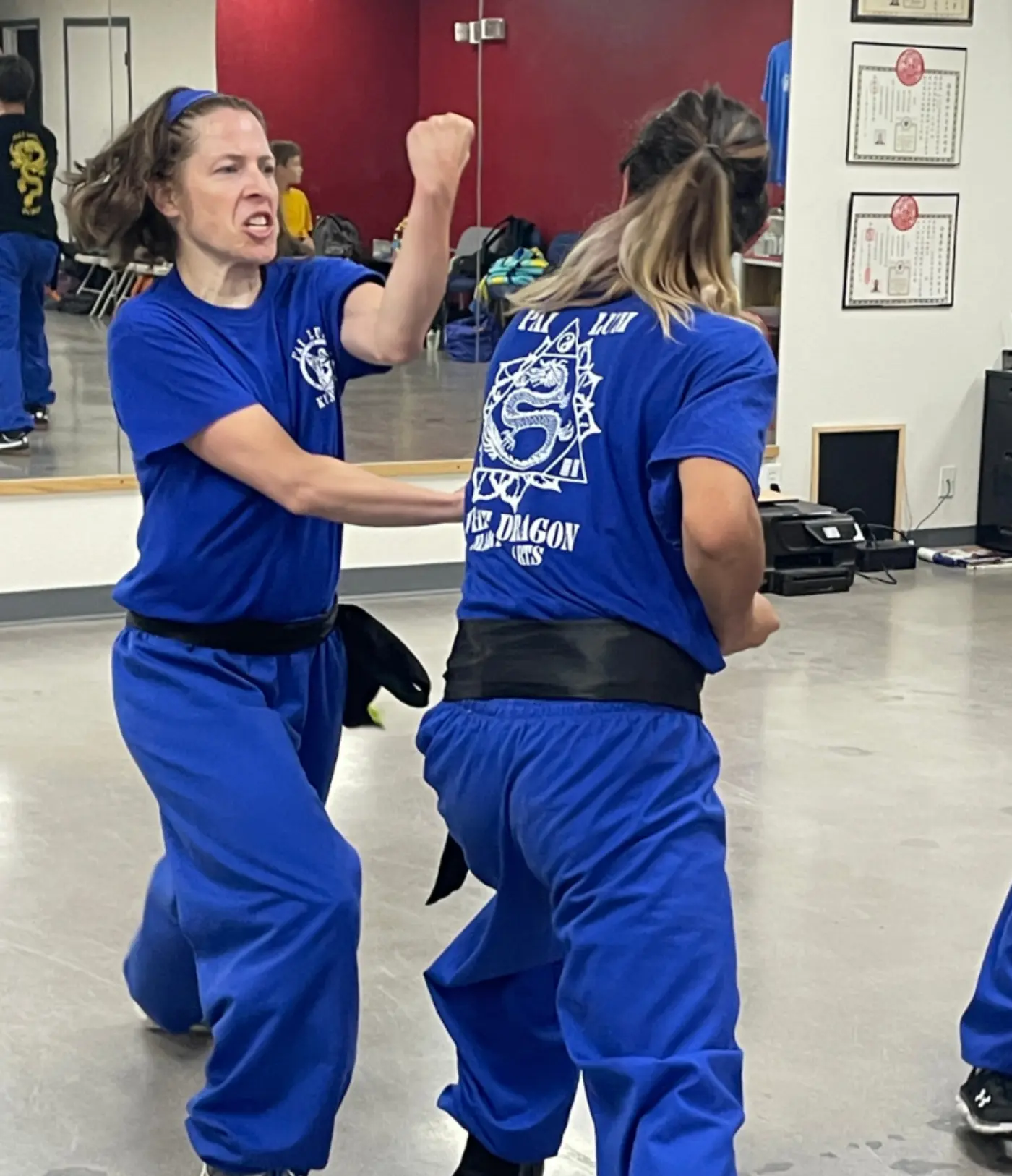 Two women practicing a self defense in class
